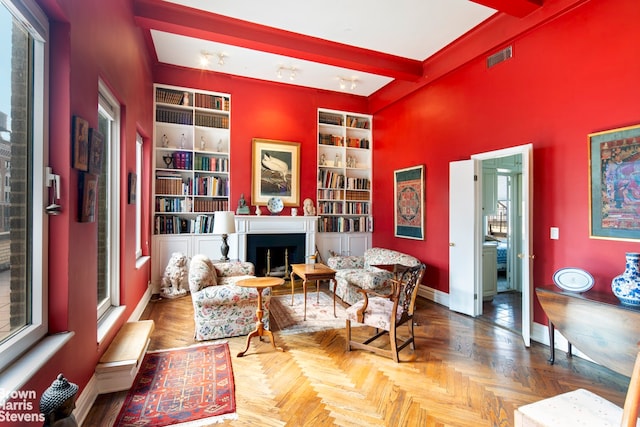 136 E 64th St Phc, Phc, New York City, NY 10065 - living area featuring baseboards, a fireplace, built in shelves, and beamed ceiling