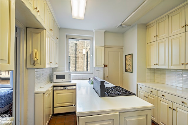 136 E 64th St Phc, Phc, New York City, NY 10065 - kitchen featuring dishwasher, white microwave, decorative backsplash, light countertops, and range with gas cooktop