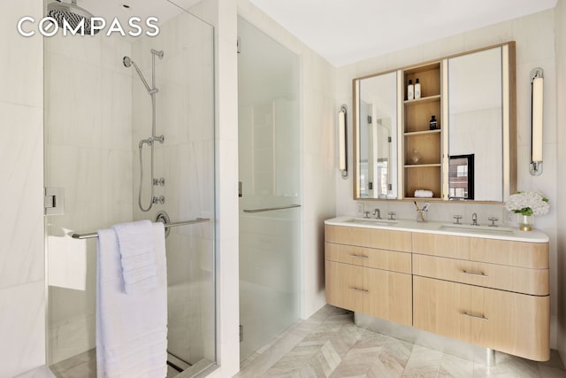 bathroom featuring a shower stall and double vanity