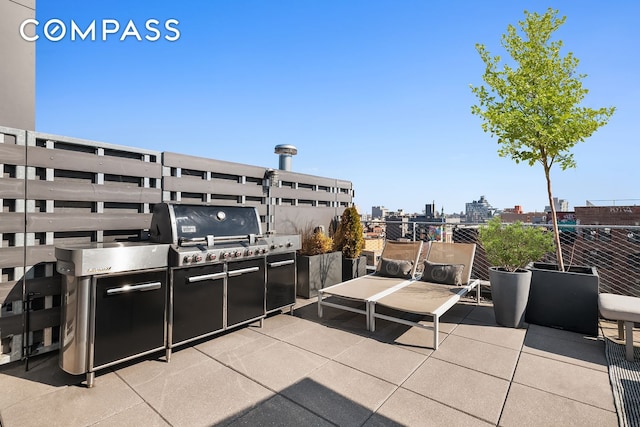 view of patio / terrace featuring a view of city and area for grilling