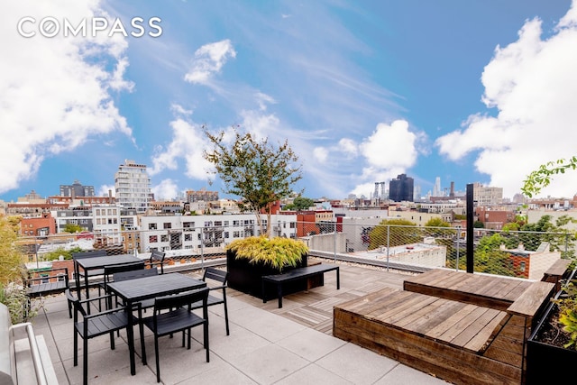 wooden terrace featuring a view of skyline