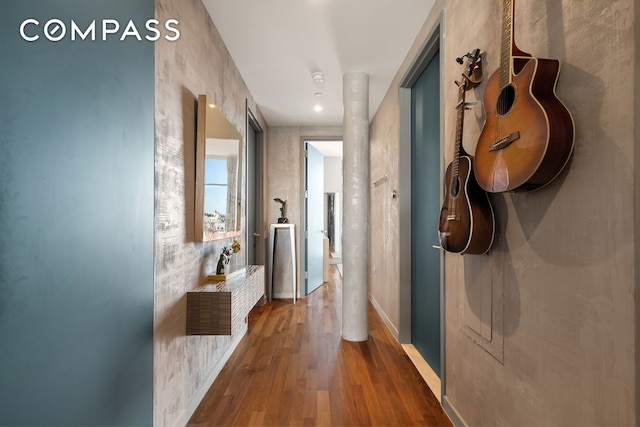 hall with wood finished floors and baseboards