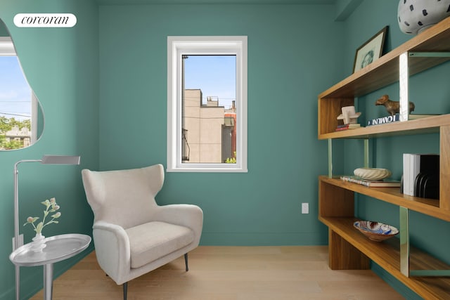 living area featuring wood finished floors and baseboards