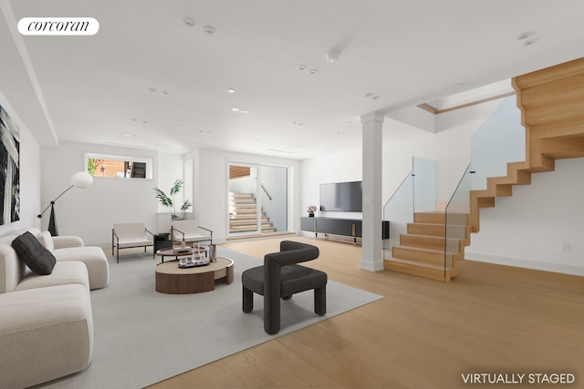 living room with stairs, wood finished floors, baseboards, and recessed lighting