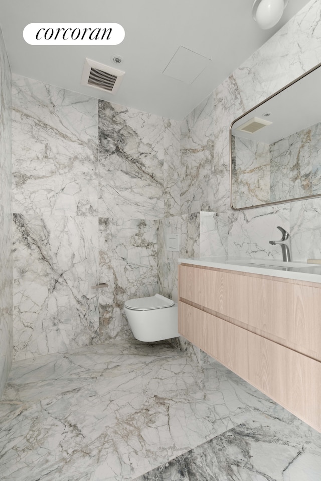 full bathroom with a marble finish shower, vanity, toilet, and marble tiled flooring