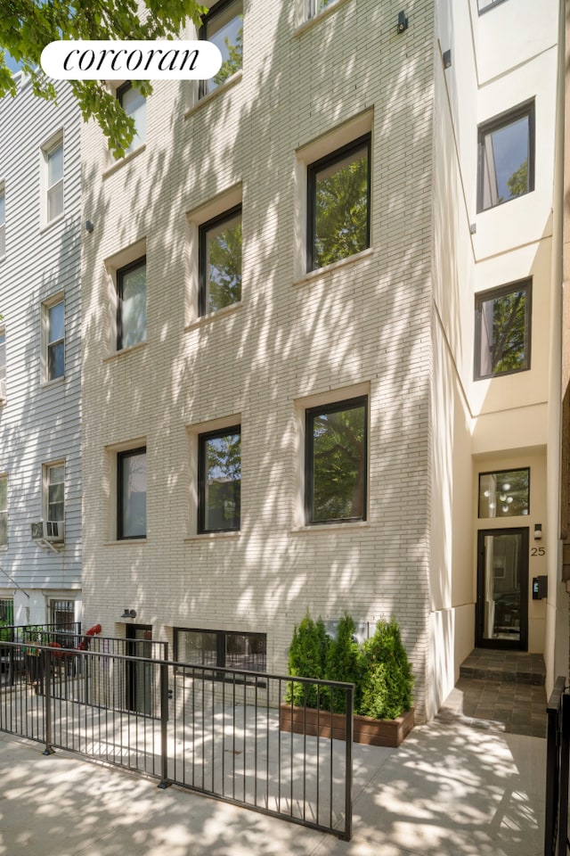 view of apartment building / complex with fence
