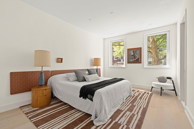 bedroom with wood finished floors and baseboards