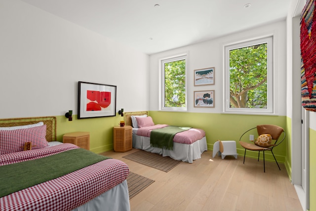 bedroom with baseboards and light wood-style flooring