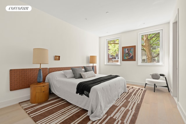 bedroom featuring wood finished floors and baseboards