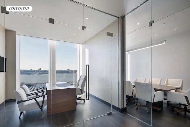 35 Hudson Yards Unit 5302, New York City, NY 10001 - dining space featuring baseboards, a water view, dark wood finished floors, a desk, and a wall of windows