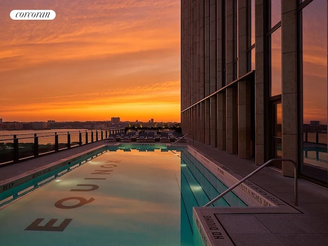 35 Hudson Yards Unit 5302, New York City, NY 10001 - pool at dusk featuring a community pool and a view of city