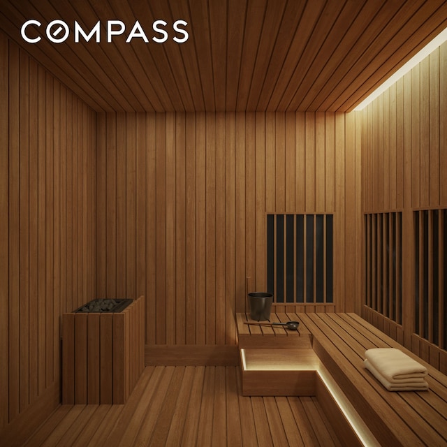 relaxing sauna / steam room featuring wood ceiling and wooden walls