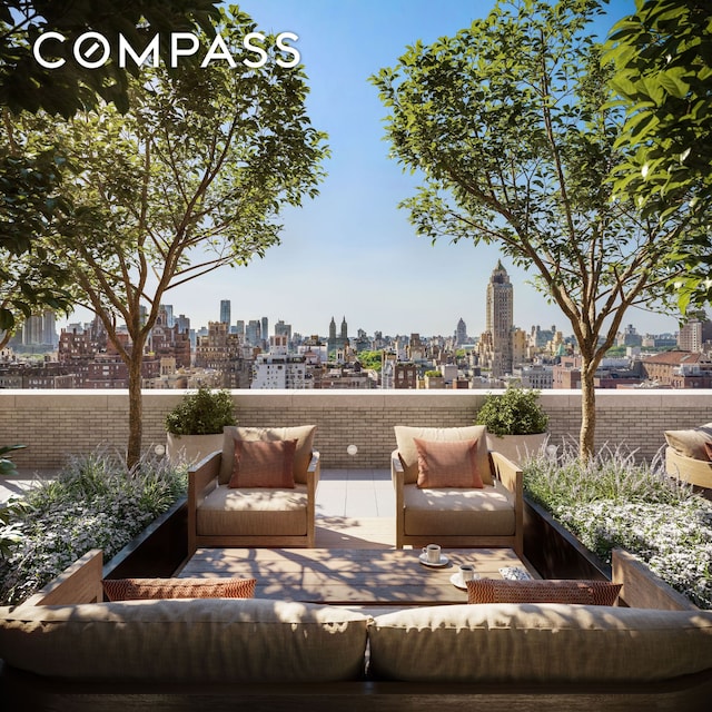 view of patio / terrace featuring a view of skyline, an outdoor hangout area, and a balcony