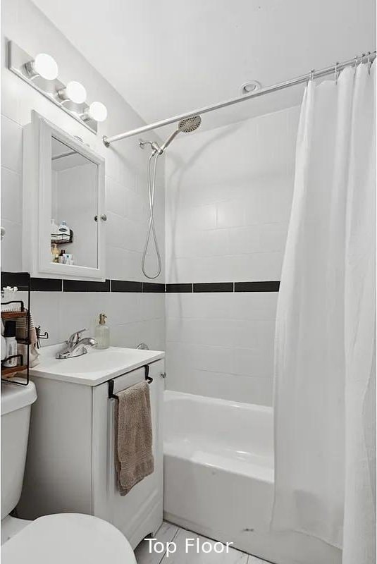 124 President St, New York City, NY 11231 - bathroom featuring toilet, shower / bath combo with shower curtain, and vanity