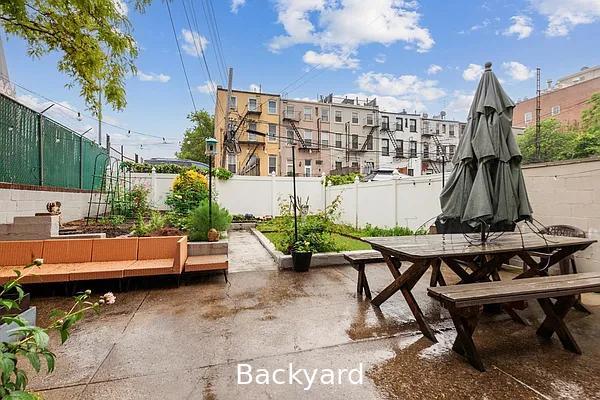 124 President St, New York City, NY 11231 - fenced backyard with outdoor dining area, a garden, and a patio area