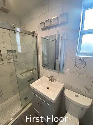 124 President St, New York City, NY 11231 - full bathroom featuring a stall shower, vanity, toilet, and tile walls