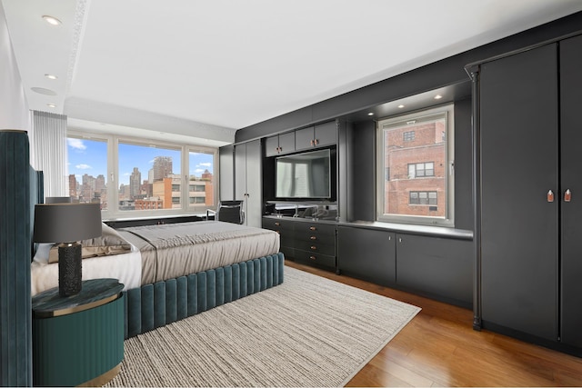 bedroom with light wood-type flooring and recessed lighting