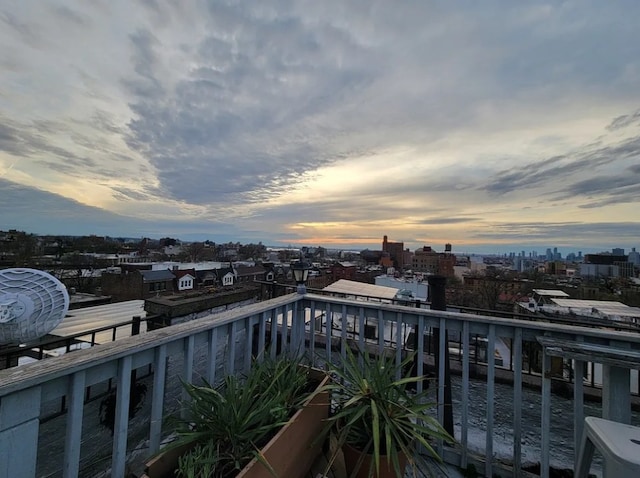 balcony at dusk featuring ac unit
