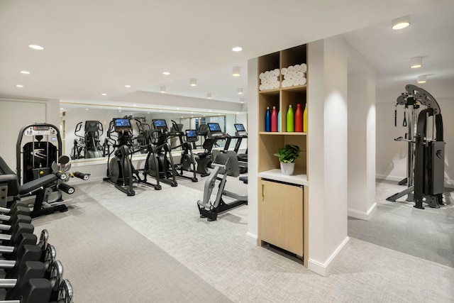 exercise room with light carpet, recessed lighting, and baseboards