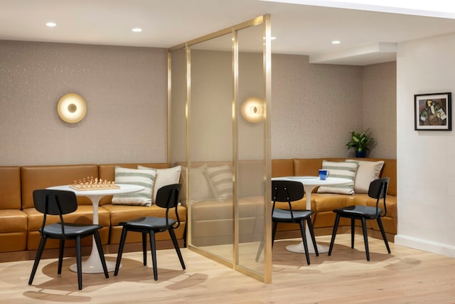dining space featuring wood finished floors, recessed lighting, baseboards, and wallpapered walls