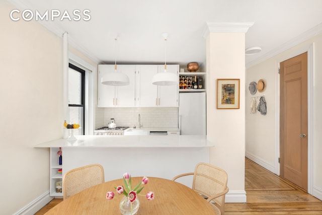 205 E 10th St Unit 3A, New York City, NY 10003 - dining area featuring crown molding and baseboards
