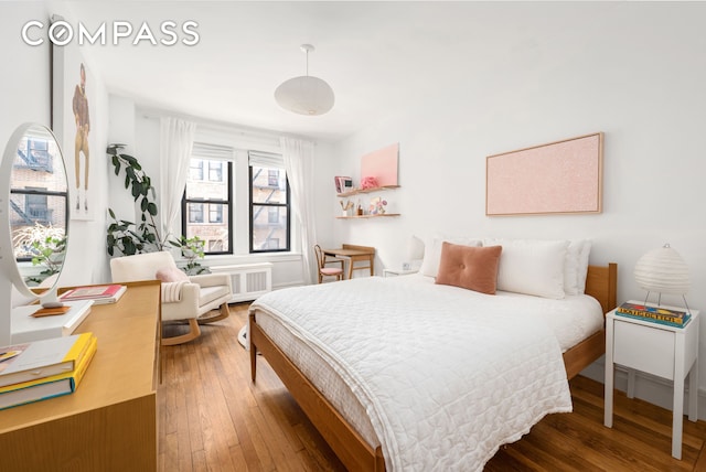 205 E 10th St Unit 3A, New York City, NY 10003 - bedroom featuring hardwood / wood-style floors and radiator
