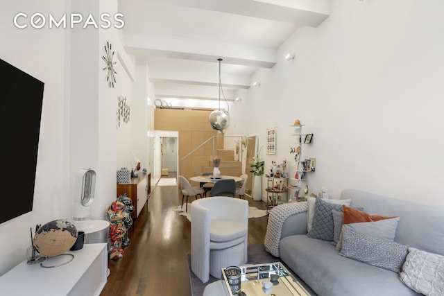 living area with wood finished floors and beamed ceiling