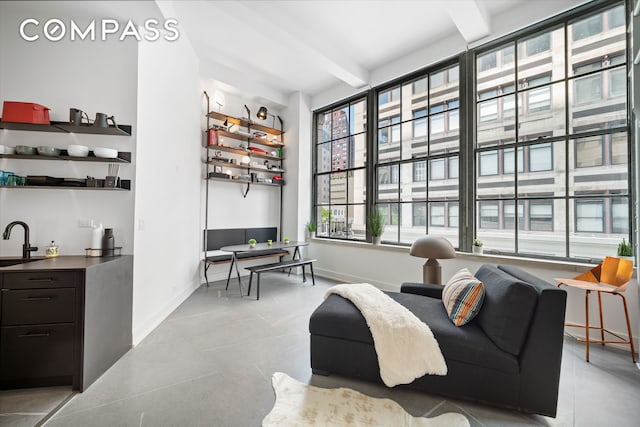 111 4th Ave Unit 1J, New York City, NY 10003 - sitting room featuring tile patterned floors, beamed ceiling, and bar with sink