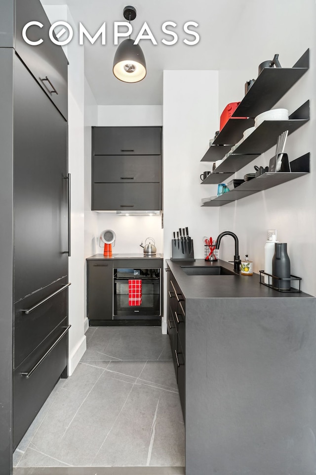 111 4th Ave Unit 1J, New York City, NY 10003 - kitchen featuring open shelves, black oven, dark countertops, light tile patterned floors, and modern cabinets