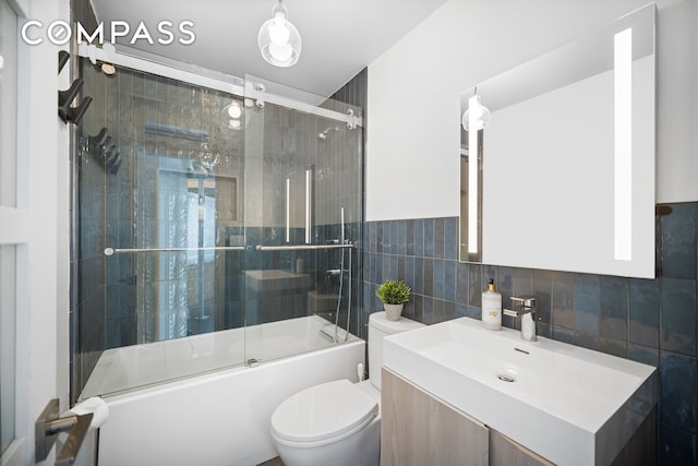 111 4th Ave Unit 1J, New York City, NY 10003 - full bath featuring tile walls, vanity, and enclosed tub / shower combo