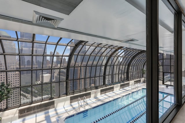 view of swimming pool featuring a city view