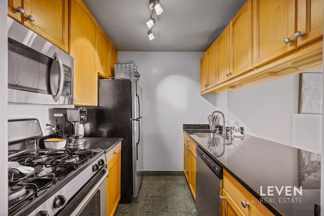 200 Rector Pl Unit 22D, New York City, NY 10280 - kitchen with appliances with stainless steel finishes, a sink, baseboards, track lighting, and a textured ceiling
