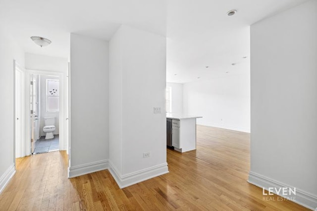 spare room with light wood-style floors and baseboards
