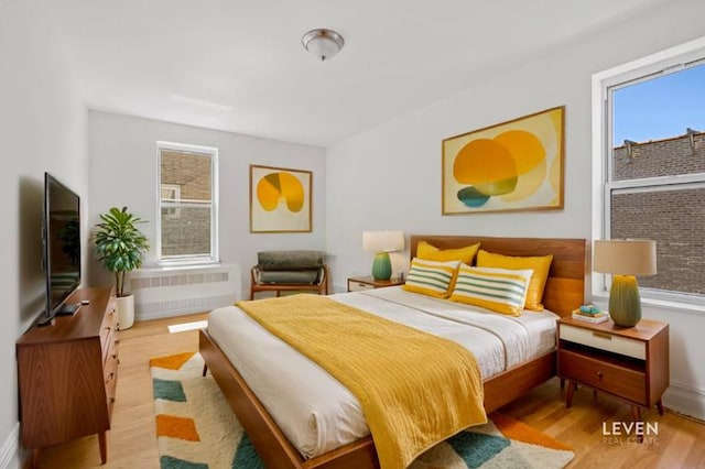 bedroom featuring wood finished floors and baseboards