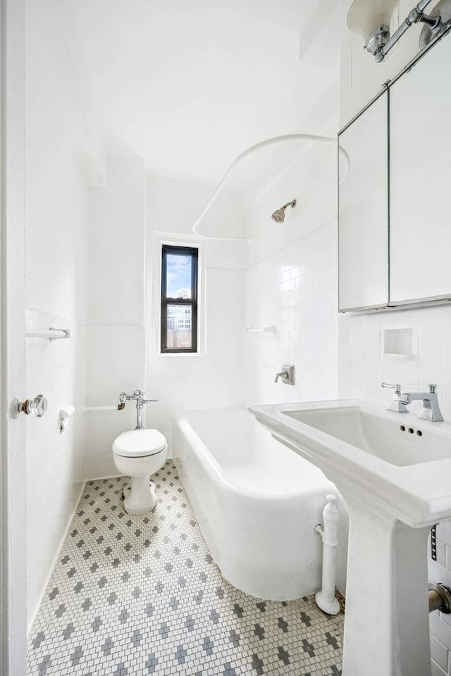bathroom featuring toilet and tile patterned floors
