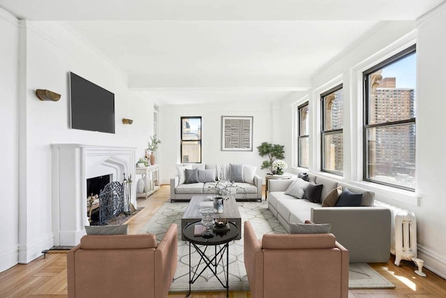 living room featuring radiator, a fireplace, baseboards, and beamed ceiling