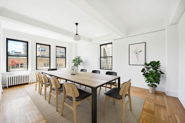 dining space featuring radiator, beamed ceiling, and baseboards