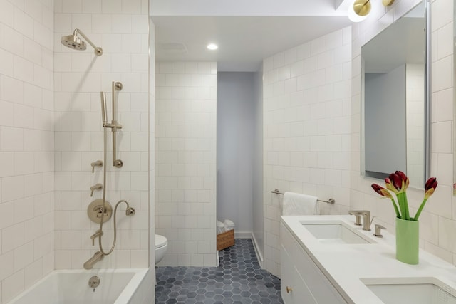 558 W 150th St Unit 101, New York City, NY 10031 - full bath featuring tile walls, toilet, bathtub / shower combination, double vanity, and tile patterned floors
