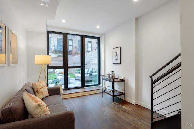 558 W 150th St Unit 101, New York City, NY 10031 - living room with recessed lighting, dark wood-type flooring, expansive windows, stairway, and baseboards