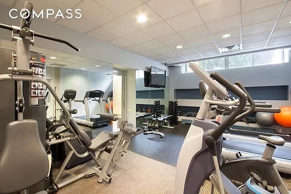 gym with a paneled ceiling and recessed lighting