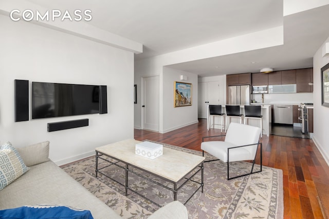 living room with dark wood-style floors and baseboards