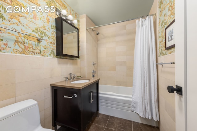 301 W 118th St Unit Ph1C, New York City, NY 10026 - bathroom featuring tile walls, vanity, shower / bath combo with shower curtain, and a wainscoted wall