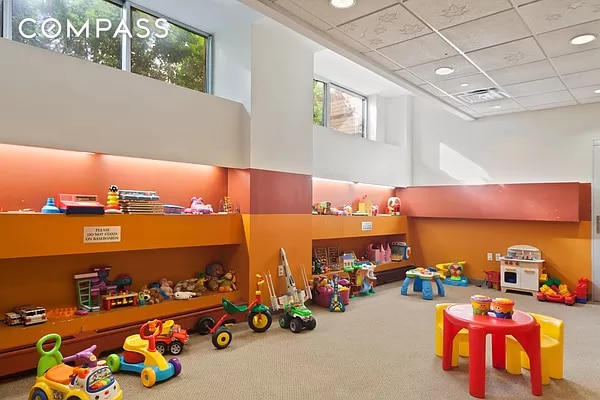 301 W 118th St Unit Ph1C, New York City, NY 10026 - recreation room featuring carpet floors, healthy amount of natural light, a drop ceiling, and a towering ceiling