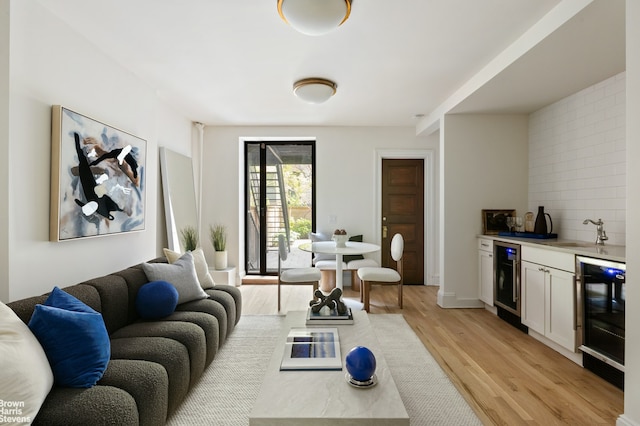 221 W 113th St, New York City, NY 10026 - living room featuring bar with sink, light wood-type flooring, and wine cooler