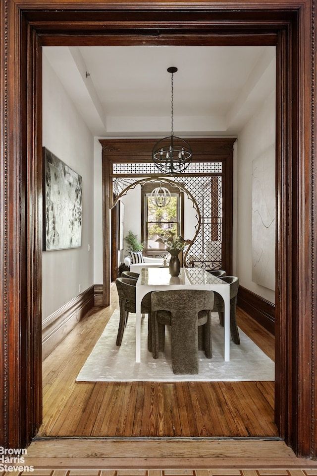 221 W 113th St, New York City, NY 10026 - dining space with a chandelier, wood finished floors, and baseboards