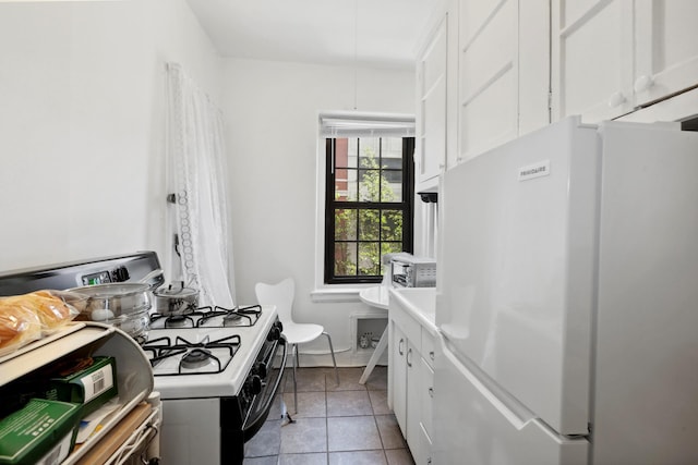 114 Clinton St Unit 3E, New York City, NY 11201 - kitchen with white appliances, white cabinets, light tile patterned flooring, and light countertops