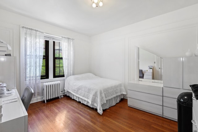 114 Clinton St Unit 3E, New York City, NY 11201 - bedroom with radiator and wood finished floors