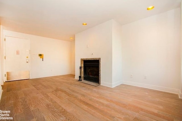 300 E 90th St Unit 9B, New York City, NY 10128 - unfurnished living room with light wood-style floors, a fireplace, and recessed lighting