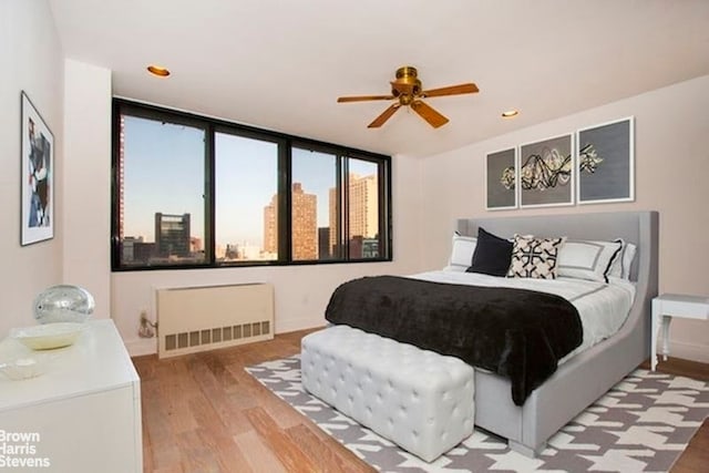 300 E 90th St Unit 9B, New York City, NY 10128 - bedroom featuring radiator, light wood-type flooring, baseboards, and recessed lighting