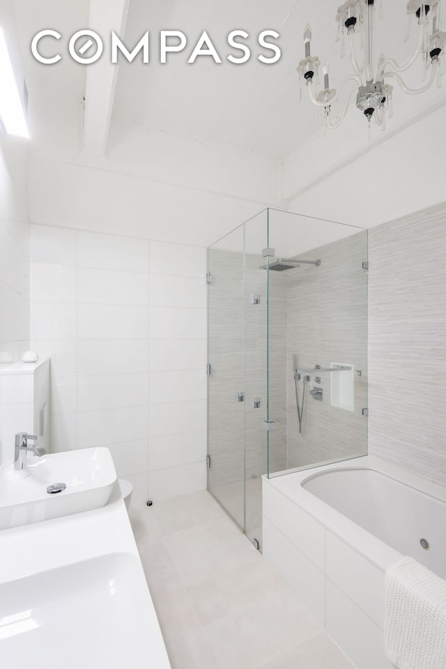 bathroom featuring a stall shower, a bath, and tile walls